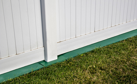 mowstrip installed on fence in yard