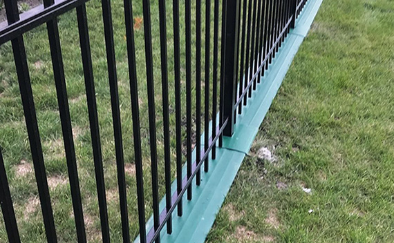 mowstrip installed on fence in yard